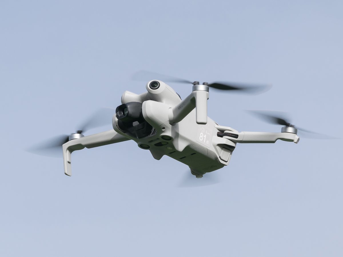 DJI Mini 4 Pro drone flying against the sky